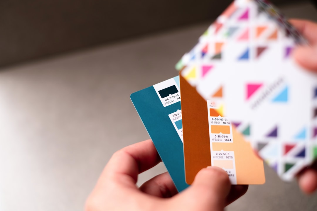 a person holding a credit card in their hand